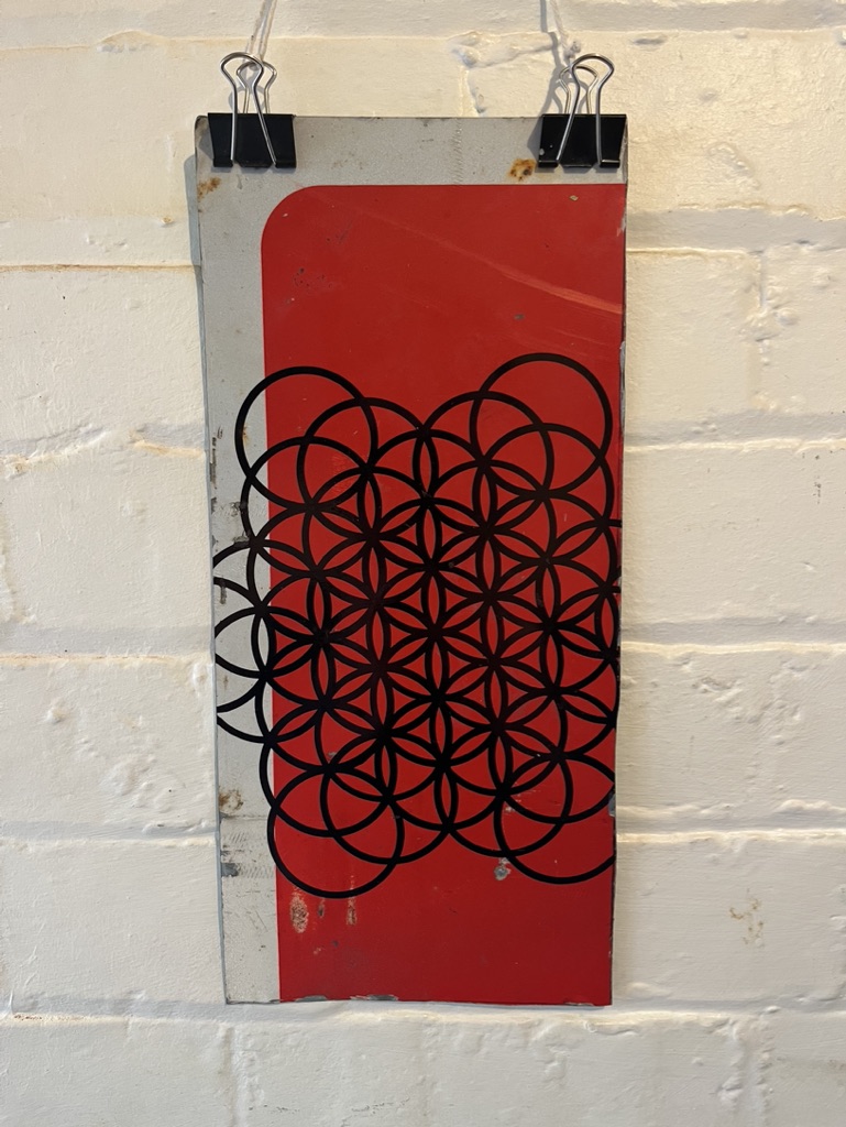 flower of life pattern in marker pen on discarded road sign