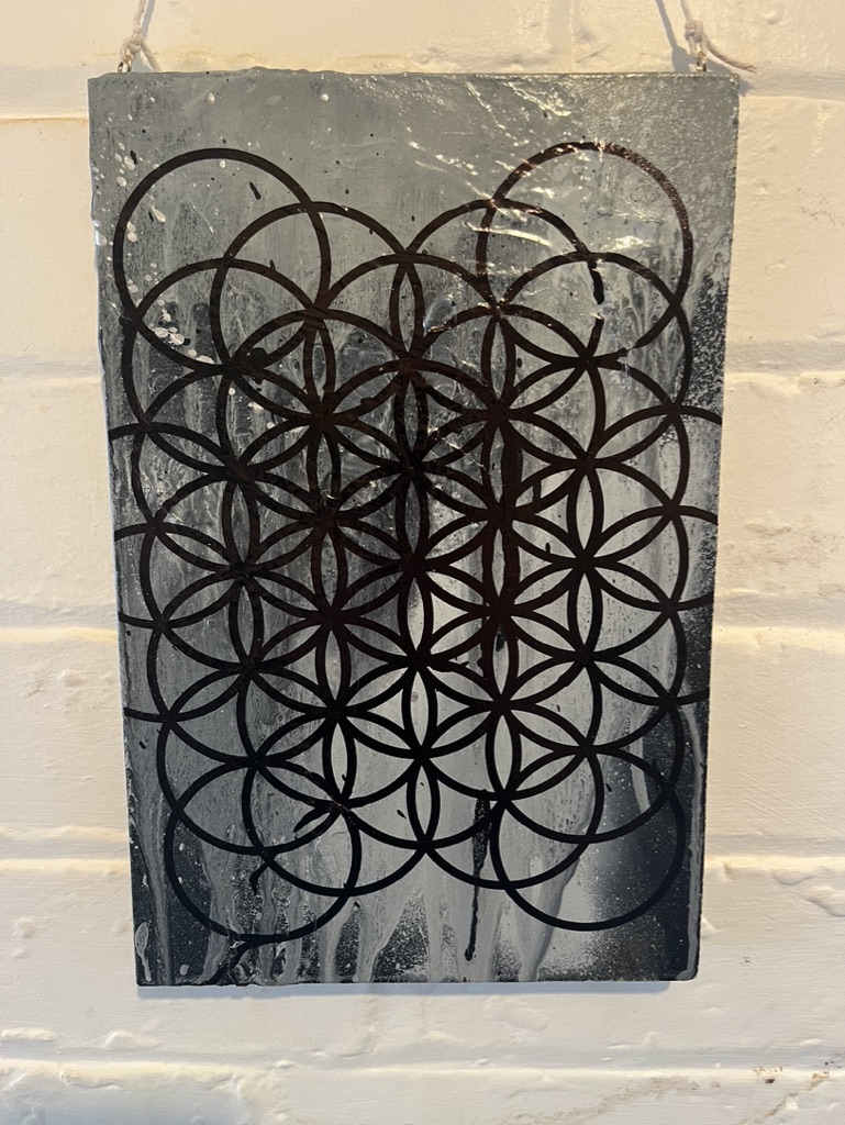 chrome and black spray paint splatter with marker pen flower of life pattern.